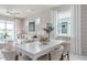 Bright dining area features a white table, seating for six, and large windows showcasing natural light and exterior views at 2333 Daisy Tree Rd, St Cloud, FL 34771