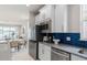 Well-equipped kitchen with stainless steel appliances, sleek countertops, and seamless transition to the dining area at 2333 Daisy Tree Rd, St Cloud, FL 34771