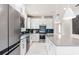 Stylish kitchen featuring a large island with seating, sleek appliances, and contemporary finishes at 2333 Daisy Tree Rd, St Cloud, FL 34771