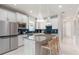 Modern kitchen with a gray countertop island, stainless steel appliances, and blue backsplash at 2333 Daisy Tree Rd, St Cloud, FL 34771