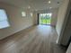 Spacious living room with wood flooring, large glass sliding doors, and ample natural light at 2333 Daisy Tree Rd, St Cloud, FL 34771