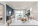 Open-concept living space with sleek furniture, stylish decor, and large glass doors providing scenic views at 2333 Daisy Tree Rd, St Cloud, FL 34771