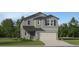 Charming two-story home with neutral gray siding, a two-car garage, and well-maintained landscaping at 2409 Bluestone Rd, Haines City, FL 33844
