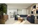 Comfortable living area featuring a plush blue sectional, stylish decor, and an open layout with natural light at 2409 Bluestone Rd, Haines City, FL 33844