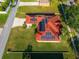 Aerial view of house featuring solar panels, a red roof and green lawn at 3174 Grasmere View Pkwy, Kissimmee, FL 34746