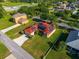 An aerial view showcasing a home with solar panels and a lush green lawn, surrounded by well-maintained landscaping at 3174 Grasmere View Pkwy, Kissimmee, FL 34746