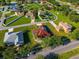 Aerial view of house featuring solar panels, a red roof, green lawn plus street view at 3174 Grasmere View Pkwy, Kissimmee, FL 34746