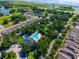 Aerial image of the community clubhouse with a swimming pool, surrounded by lush landscaping and residential homes at 3174 Grasmere View Pkwy, Kissimmee, FL 34746
