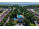 An aerial view capturing the community clubhouse, featuring a pool area, surrounded by mature trees and well-maintained landscaping at 3174 Grasmere View Pkwy, Kissimmee, FL 34746