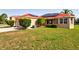 A backyard of a single Gathering home, with solar panels, a well maintained lawn, and nice shrubbery at 3174 Grasmere View Pkwy, Kissimmee, FL 34746