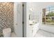 Stylish bathroom with modern fixtures, tile accent wall, and double vanity at 3174 Grasmere View Pkwy, Kissimmee, FL 34746