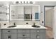 Modern bathroom featuring a double vanity with unique vessel sinks and an illuminated mirror at 3174 Grasmere View Pkwy, Kissimmee, FL 34746