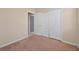 This bedroom has neutral walls, carpet, and closet doors at 3174 Grasmere View Pkwy, Kissimmee, FL 34746