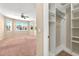 Large bedroom with carpeted flooring and bright light with an accessible closet at 3174 Grasmere View Pkwy, Kissimmee, FL 34746