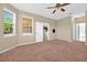 Spacious bedroom features plush carpeting, a ceiling fan, and large windows for natural light at 3174 Grasmere View Pkwy, Kissimmee, FL 34746