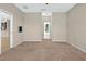 Neutral bedroom with beige carpet and walls, an open doorway and a glimpse into the kitchen at 3174 Grasmere View Pkwy, Kissimmee, FL 34746