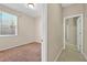 Bedroom with neutral carpet, a bright window, and a view into the hallway at 3174 Grasmere View Pkwy, Kissimmee, FL 34746