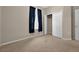 This bedroom has neutral walls, carpet, and a window with dark curtains and closet at 3174 Grasmere View Pkwy, Kissimmee, FL 34746