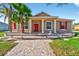 Charming single-Gathering home with red shutters and a matching red front door and a landscaped front yard at 3174 Grasmere View Pkwy, Kissimmee, FL 34746