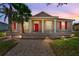 Charming single-Gathering home with red shutters and a matching red front door and a landscaped front yard at 3174 Grasmere View Pkwy, Kissimmee, FL 34746