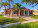 Charming single-Gathering home with red shutters and a matching red front door and a landscaped front yard at 3174 Grasmere View Pkwy, Kissimmee, FL 34746