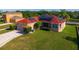 Well-maintained one-story home with red roof, solar panels, green lawn, and attached garage at 3174 Grasmere View Pkwy, Kissimmee, FL 34746