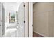 Hallway view showcases the entrance to the bathroom with tile flooring and a wire rack shelf at 3174 Grasmere View Pkwy, Kissimmee, FL 34746