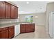 Spacious kitchen with stainless appliances, wood cabinets, and backyard views at 3174 Grasmere View Pkwy, Kissimmee, FL 34746