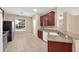 Clean kitchen with stainless steel appliances, tile floors, and wood cabinets at 3174 Grasmere View Pkwy, Kissimmee, FL 34746