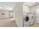 Laundry room with a washer and dryer, plus access to the main living area at 3174 Grasmere View Pkwy, Kissimmee, FL 34746