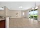 Large living room features tiled floors and sliding door access to the lanai at 3174 Grasmere View Pkwy, Kissimmee, FL 34746