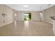 Spacious living room with tile flooring, neutral walls, sliding glass doors, and plenty of natural light at 3174 Grasmere View Pkwy, Kissimmee, FL 34746