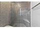 Contemporary walk-in shower with gray stone-look tile and mosaic wall, plus a built-in seat at 3174 Grasmere View Pkwy, Kissimmee, FL 34746