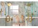 Spacious double shower with gold hardware, rain shower heads, and built-in benches at 3174 Grasmere View Pkwy, Kissimmee, FL 34746