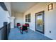 Outdoor balcony with a glass table and seating, accessible from interior living spaces at 4013 Breakview Dr # A407, Orlando, FL 32819