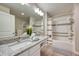 Bright bathroom with double sink granite-topped vanity, shower, and safety bars for accessibility at 4013 Breakview Dr # A407, Orlando, FL 32819