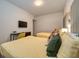 Comfortable bedroom featuring two beds, a desk, and a wall-mounted TV for relaxation and entertainment at 4013 Breakview Dr # A407, Orlando, FL 32819