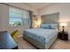 Bright bedroom with a plush bed, desk area and large window with neighborhood views at 4013 Breakview Dr # A407, Orlando, FL 32819