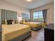 Inviting bedroom showcasing two beds, a window, and stylish decor for a comfortable stay at 4013 Breakview Dr # A407, Orlando, FL 32819