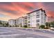 Wide view of the condo complex with ample parking under a stunning sky at 4013 Breakview Dr # A407, Orlando, FL 32819