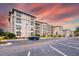 Condominium complex exterior with ample parking, mature trees, and landscaping at 4013 Breakview Dr # A407, Orlando, FL 32819