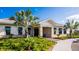 Community clubhouse with stone accents, a welcoming entrance, lush landscaping, and a paver walkway at 4066 Old Mill Rd, Haines City, FL 33844