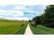 Community walking path with lush landscaping and views of the homes in this beautiful new community at 4066 Old Mill Rd, Haines City, FL 33844