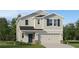 Charming two-story home with a well-maintained lawn and a two-car garage at 4070 Old Mill Rd, Haines City, FL 33844