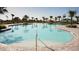 Large community pool surrounded by palm trees and plenty of space for residents to relax and enjoy at 4078 Old Mill Rd, Haines City, FL 33844