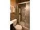 Contemporary bathroom showcasing a tiled shower with glass door, toilet and vanity at 410 5Th S St, Dundee, FL 33838