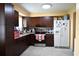 A functional kitchen showcasing dark cabinetry, stainless steel appliances, and ample counter space at 410 5Th S St, Dundee, FL 33838