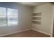 Bright living room with built-in shelving and a window, perfect for relaxation and entertaining at 417 Southern Pecan Cir # 201, Winter Garden, FL 34787
