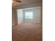Spacious living room filled with natural light from a large window, perfect for relaxation at 417 Southern Pecan Cir # 201, Winter Garden, FL 34787