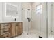Bathroom featuring a wood-grain vanity, glass-enclosed shower with an illuminated mirror and black hardware at 4528 Yorkshire Ln, Kissimmee, FL 34758